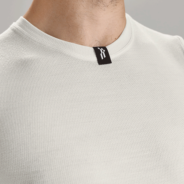 Rolling three images, studio close ups of white merino base layer.