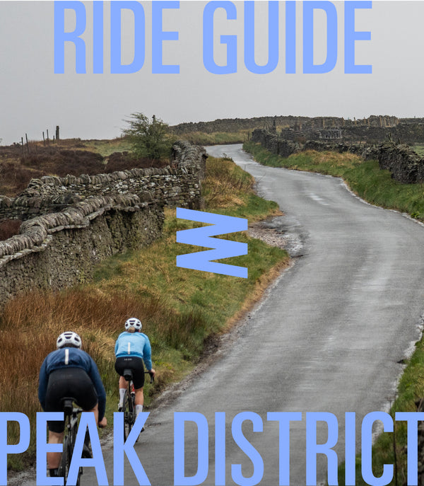 Peak district landscape, stone wall lined roads with two cyclists riding away
