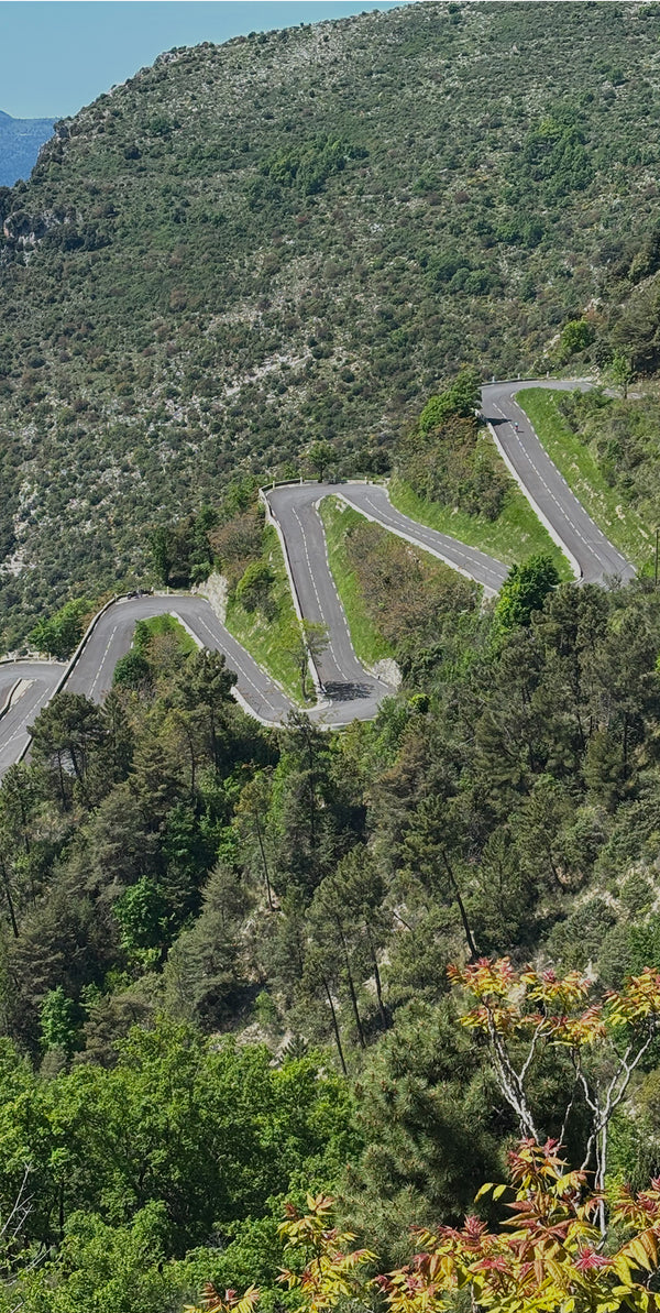 Landscape of a road with hairpin bends down a mountainside