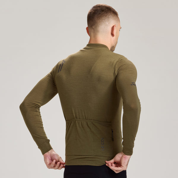 Back view studio shot of man in a olive brown merino jersey.
