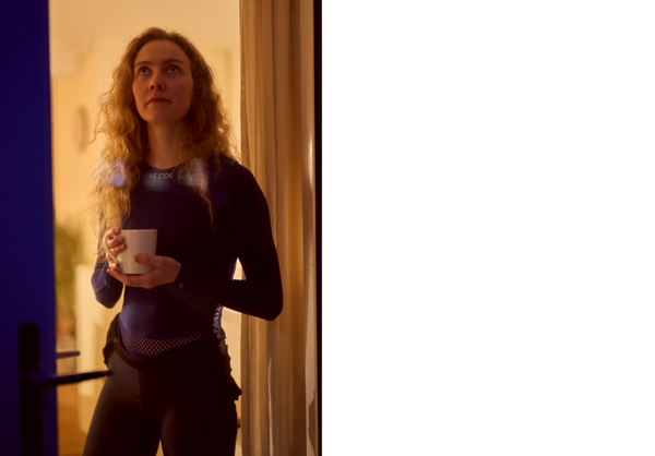 Women stand in doorway with mug in longsleeve mesh base layer.