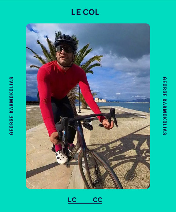 Male cyclist on a seafront road wearing a red long sleeve jersey