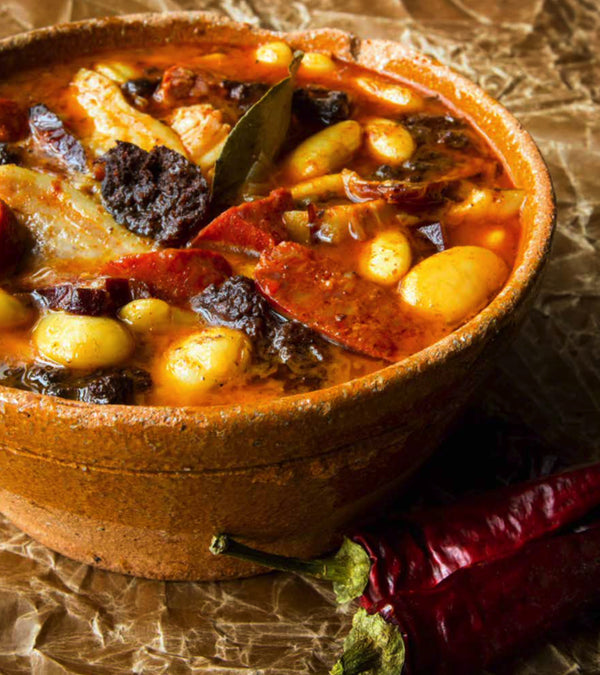 Close up of Bean stew, potato and sausage chunks in sauce.