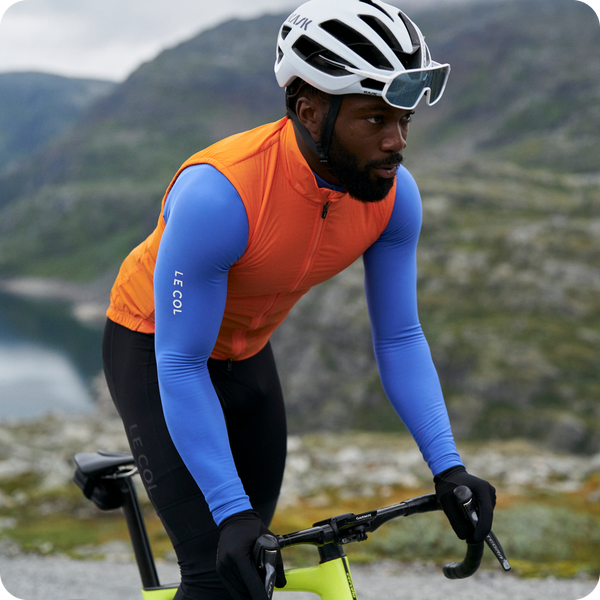 Male cyclist in saffron pro insulated gilet