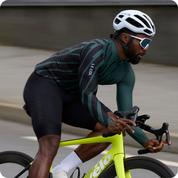 Male cyclist in stripe pattern pro long sleeve jersey.