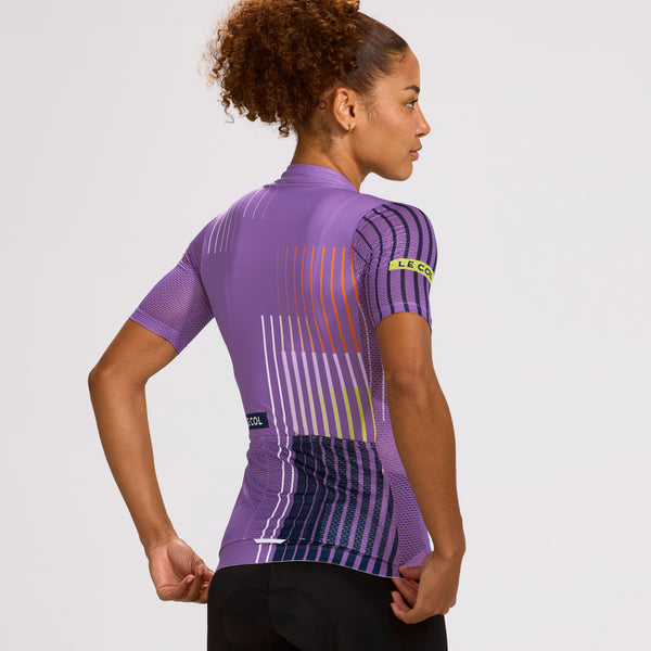 Studio shot of the back of female in new purple jersey with navy and white stripe pattern.