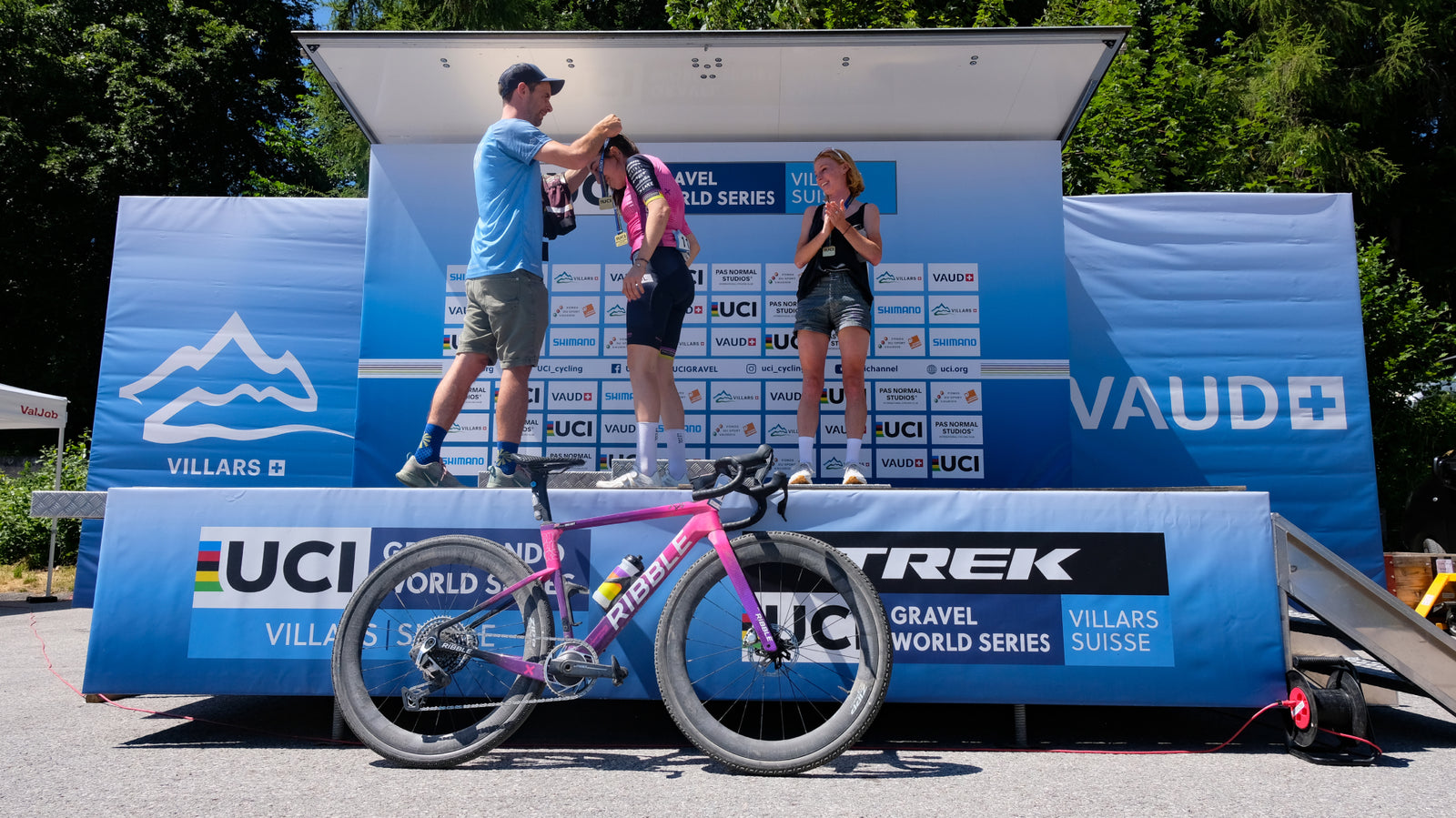 Ribble female cyclist receiving a medal on the podium stage