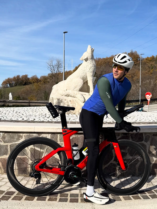 Tommasso paused on his bike in Le Col kit, a howling wolf statue behind.