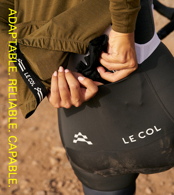 Showing female rider putting gloves in the extra rear pockets.