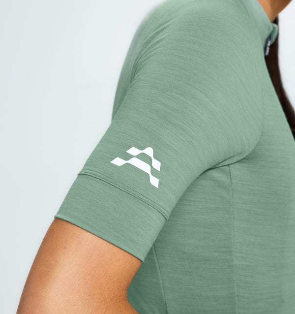 Studio close up showing lichen green merino jersey.