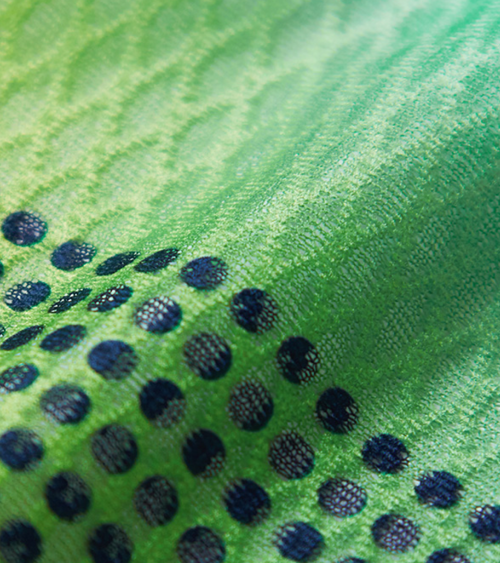 Close up of the diamond textured fabric, green to blue gradient with navy dots