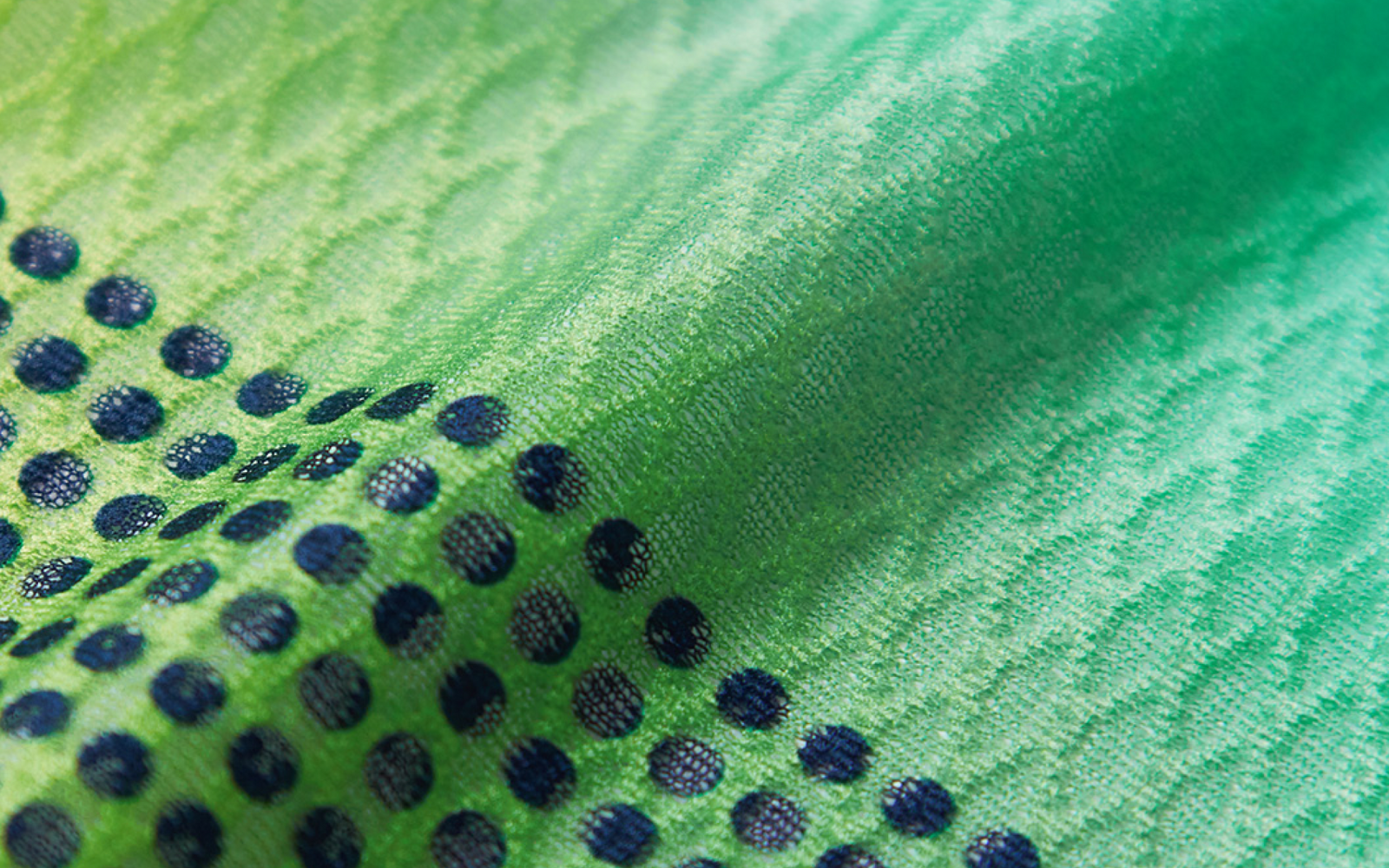 Close up of the diamond textured fabric, green to blue gradient with navy dots