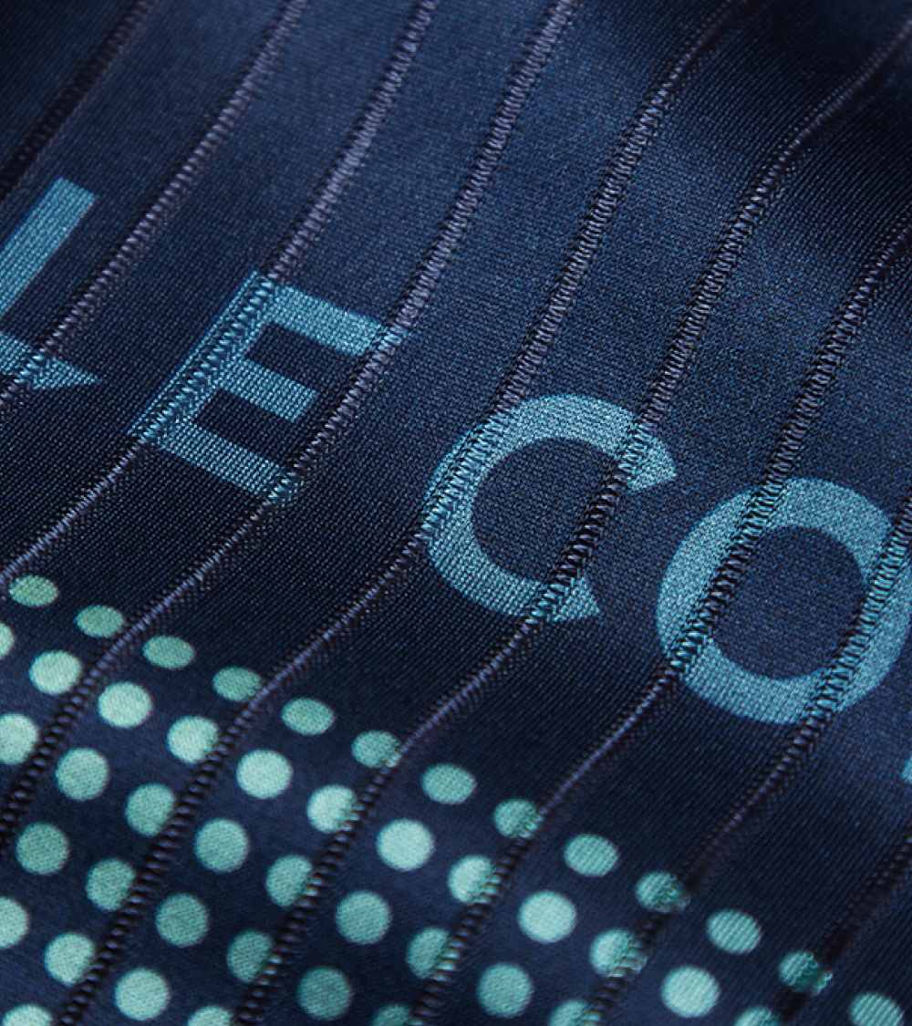 Close up of the ribbed navy fabric with Le Col and rows of dots in light blue