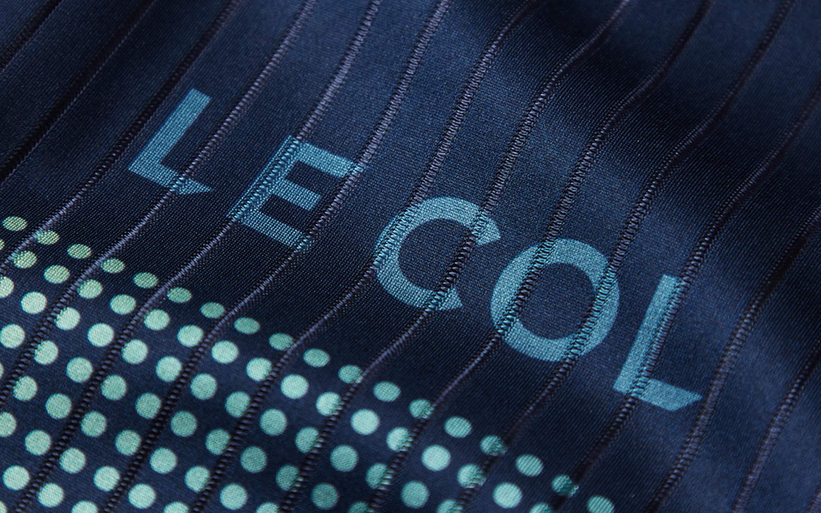 Close up of the ribbed navy fabric with Le Col and rows of dots in light blue
