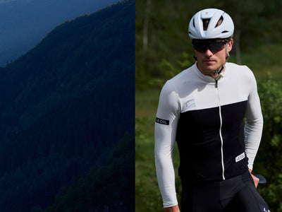 male and female cyclists riding towards the frame in blue and black jerseys