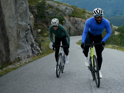 Two cyclists on a mountain trail with scenic background