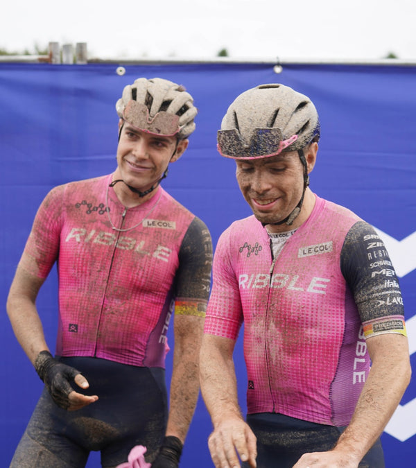 Two male Ribble cyclists, post-race with mud splattered faces and kit.