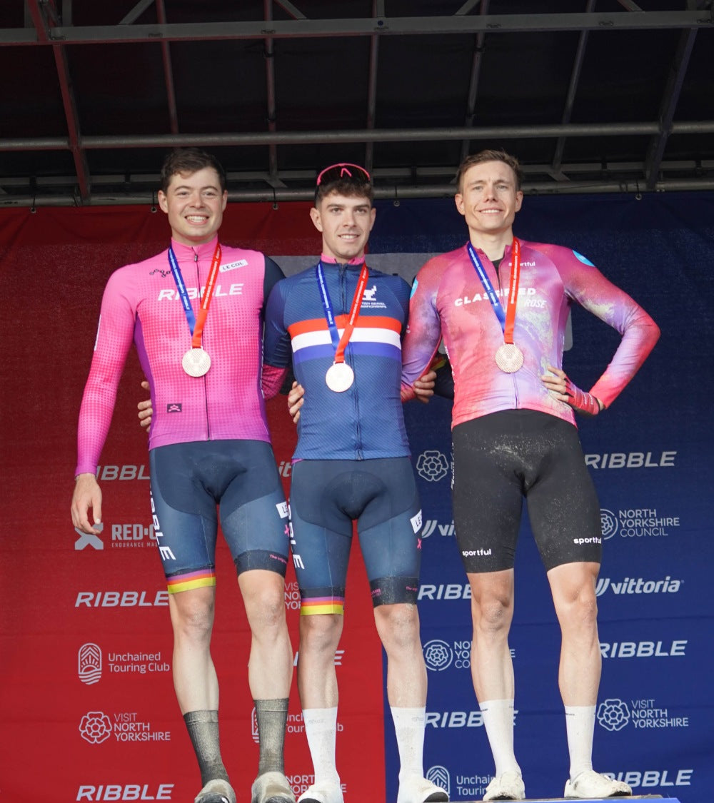 Three winning male cyclists with their medals, on the left a Ribble member.