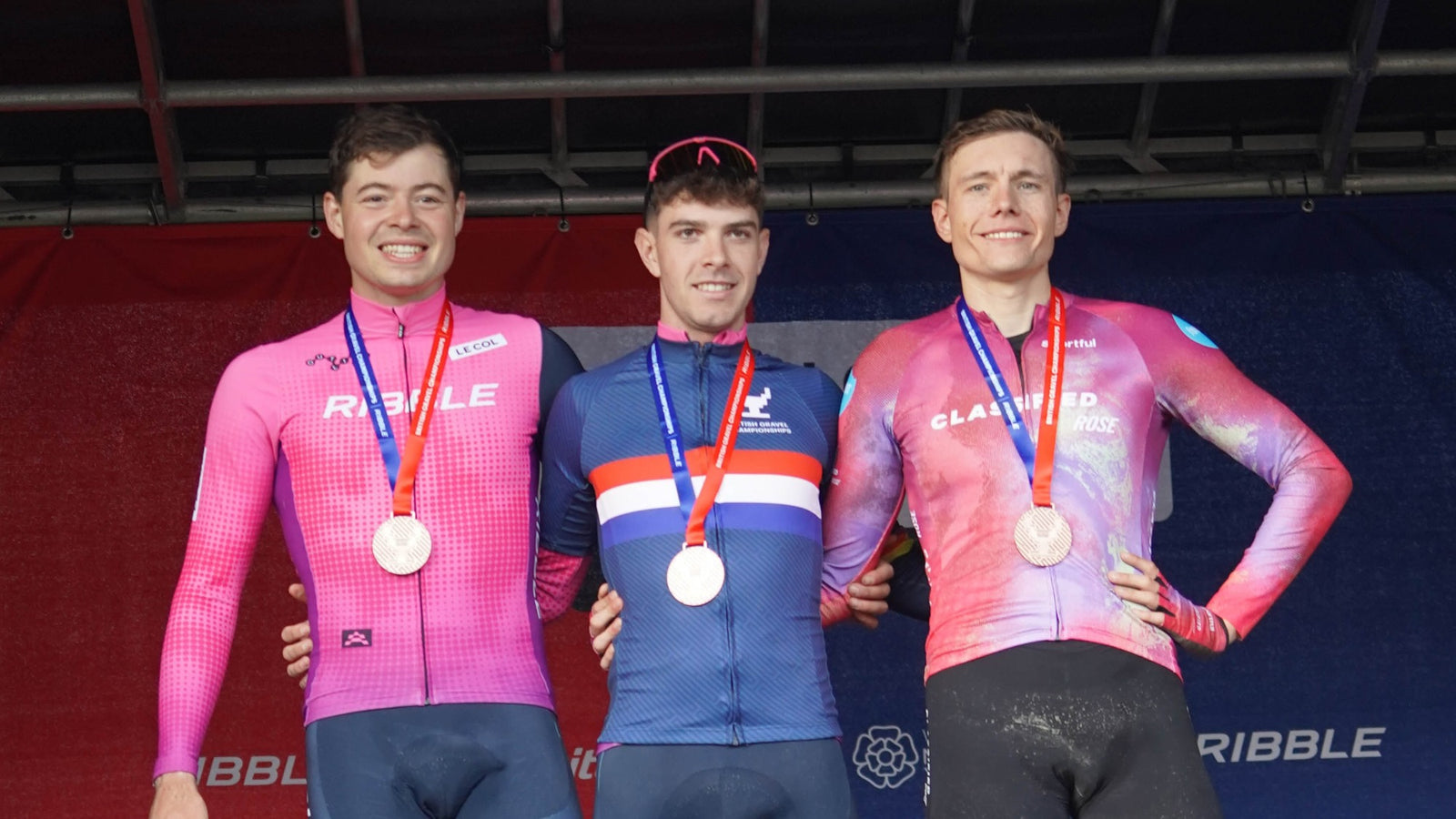 Three winning cyclists with their medals, on the left a Ribble member.