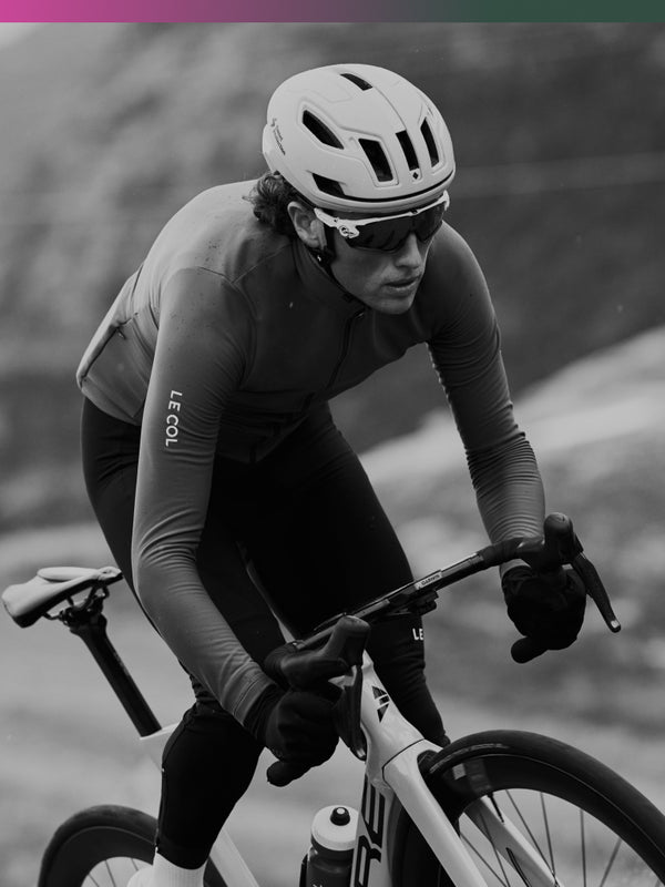 Black and white shot of male cyclist in long sleeve jersey.