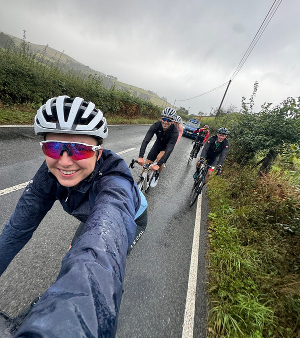 Bike selfie of five cyclists on a country road.