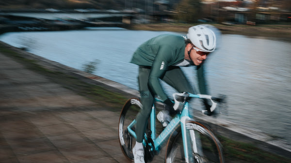 Blurred shot of james cycling alongside the river.
