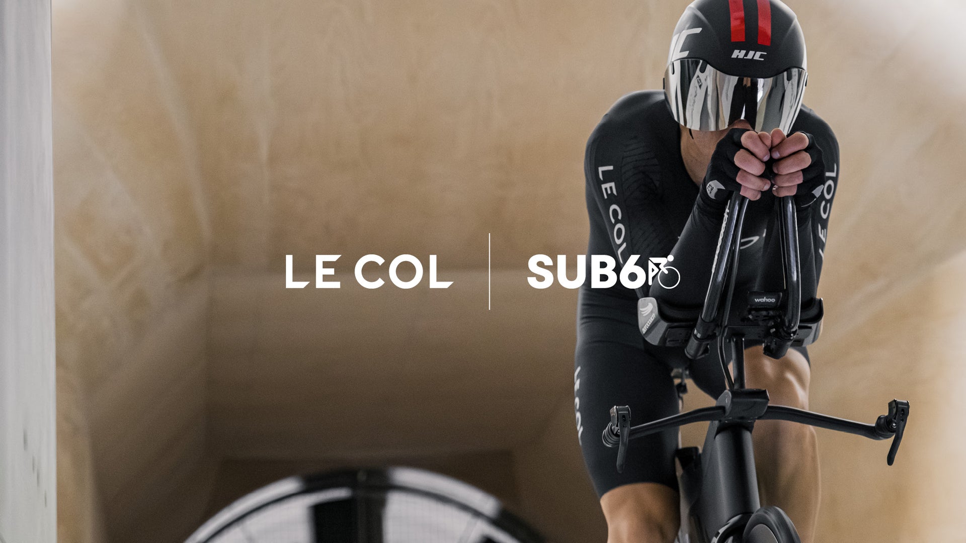 Male cyclist leant forward over the bike in a wind tunnel