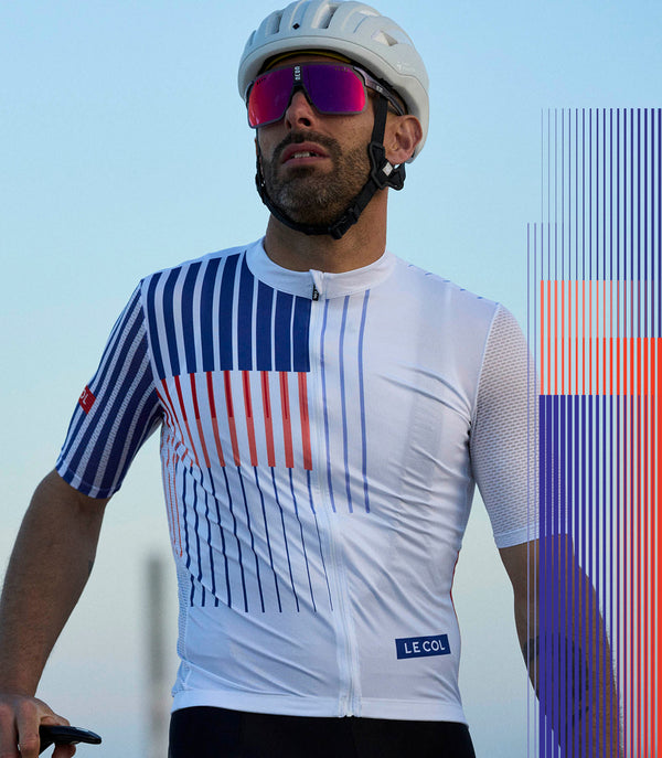 Male cyclist in the new lightweight jersey, white with blue and orange stripe pattern.