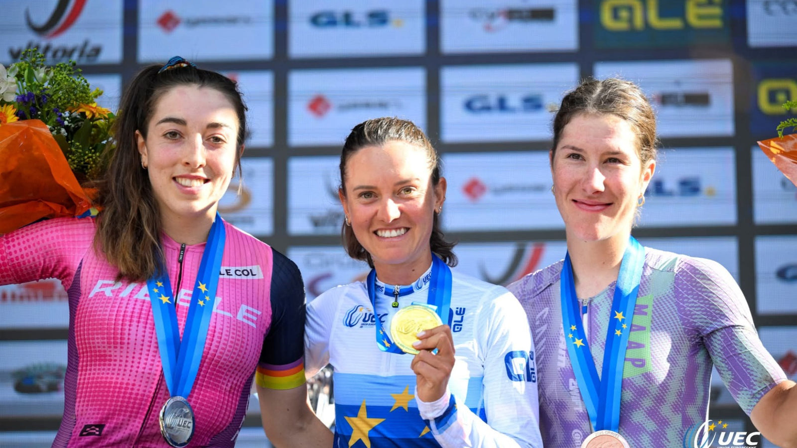 Three winning female cyclists with their medals, on the left a Ribble member.