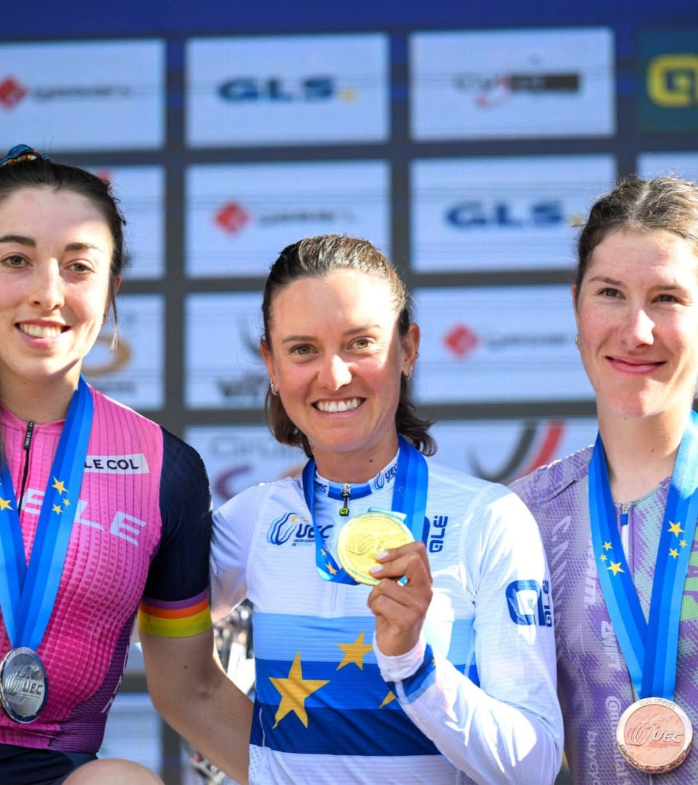 Three winning female cyclists with their medals, on the left a Ribble member.