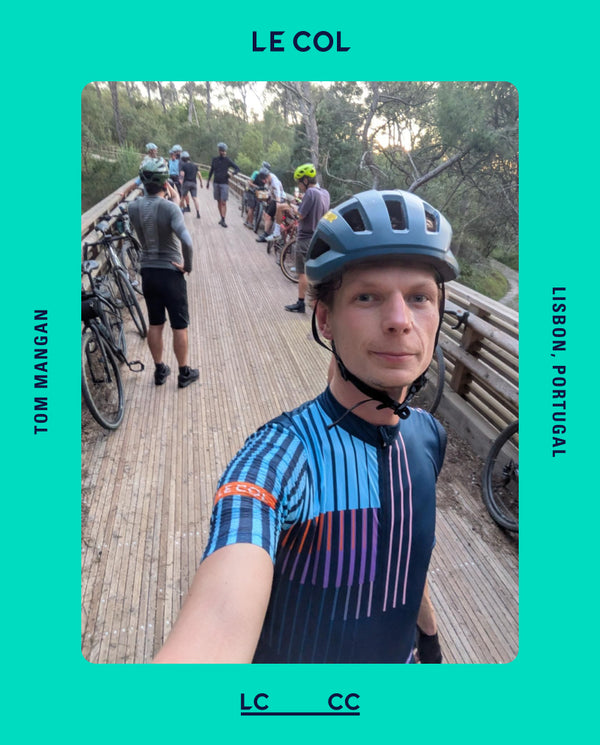 Male cyclist selfie with cycling group on a wooden bridge behind