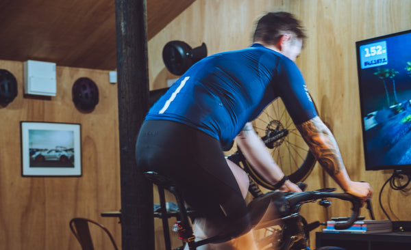 Chris on a static bike, training inside.