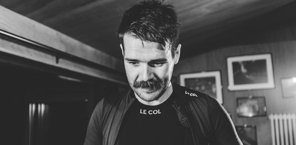 Black and white shot of Chris in Le Col kit inside a house.