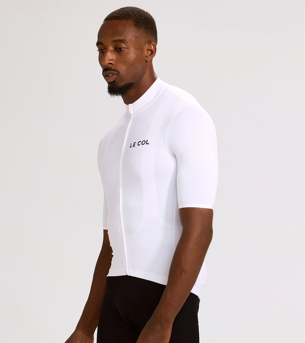 Studio shot of man wearing a white jersey with 'Le Col' in black on the left breast.
