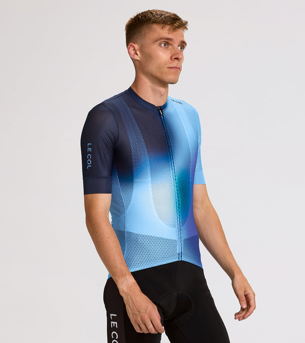 Studio shot of man wearing a navy and light blue mesh jersey with 'Le Col' branding