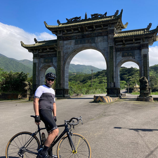 Shawn paused in front of a Taiwanese three-arched gate over the road.